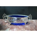 A GEORGIAN STYLE SILVER PLATED DISH of oval outline with foliate pierced sides,