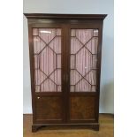 A GEORGIAN STYLE MAHOGANY WARDROBE the moulded cornice above a dentil inlaid frieze with a pair of