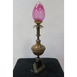 A REGENCY STYLE GILT BRASS AND FAUX TABLE LAMP of circular tapering form headed by a cut glass ruby