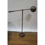 AN EARLY 20th CENTURY LEATHER UPHOLSTERED ADJUSTABLE STANDING LIGHT,