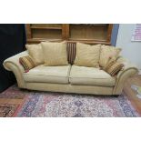 A MODERN GOLD VELVET UPHOLSTERED SCROLLED END THREE SEATER SOFA,