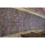 A WOOL RUNNER, the salmon pink ground decorated overall with geometric,