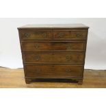 A GEORGIAN MAHOGANY CHEST OF DRAWERS with rectangular top and moulded rim above two short and three