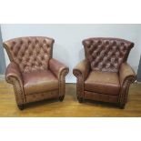 A PAIR OF BROWN LEATHER UPHOLSTERED ARMCHAIRS OF LARGE PROPORTIONS,