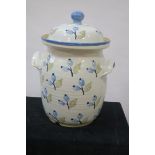A 20TH CENTURY PAINTED AND GLAZED POTTERY STORAGE JAR AND COVER circular tapering form cream ground