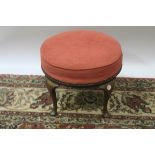 A 19TH CENTURY MAHOGANY FRAMED FOOTSTOOL the pink circular upholstered top with brass reeded rim on