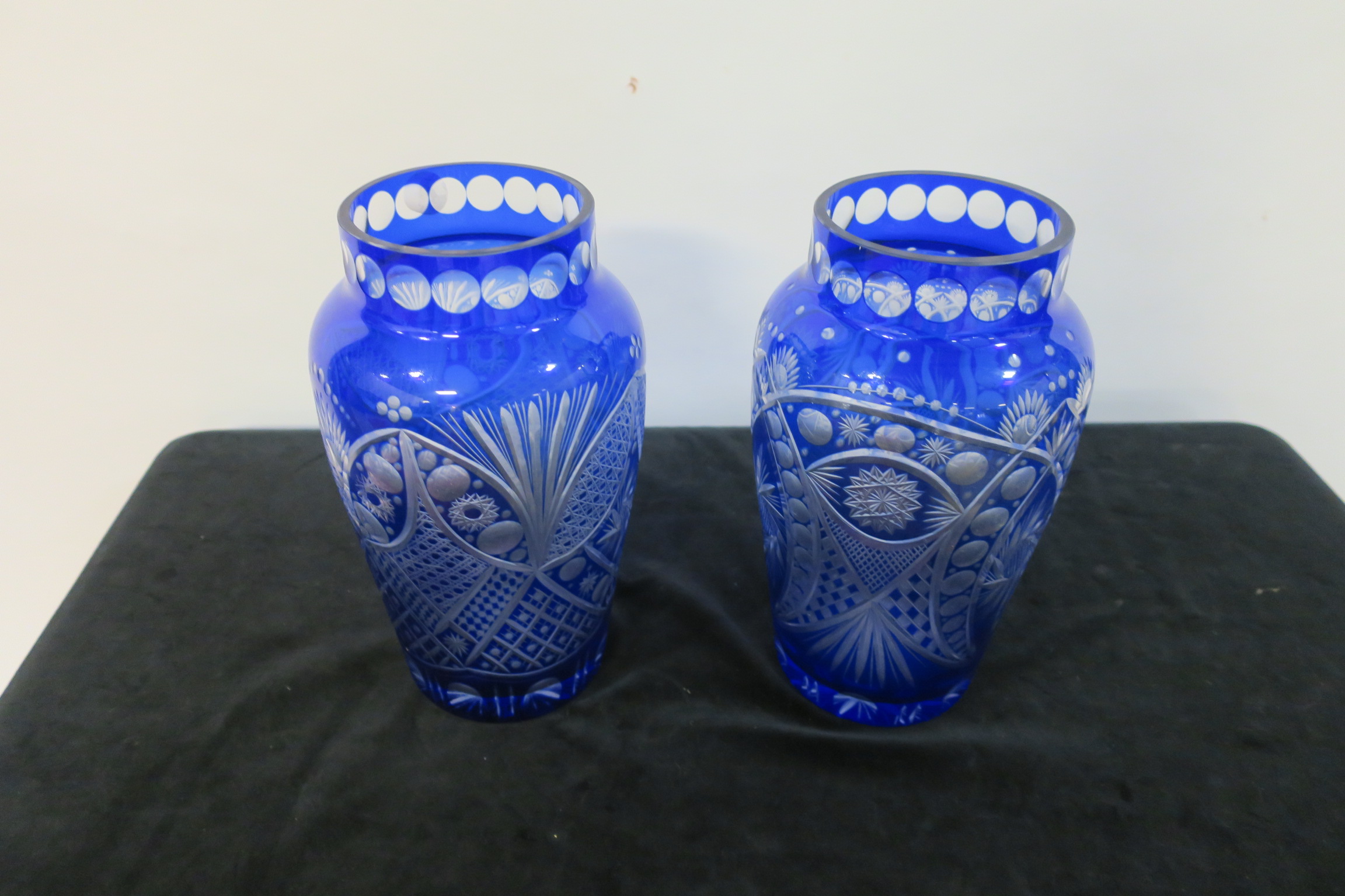 A PAIR OF COBALT BLUE CUT GLASS VASES of circular tapering form.