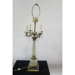 A NEO-CLASSICAL STYLE GILT BRASS AND CUT GLASS TABLE LAMP the brass stem applied with four scrolled
