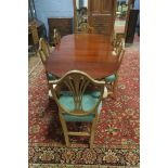 A MAHOGANY DINING ROOM SUITE comprising an oval top table with reeded rim raised on twin pillar