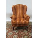 A GEORGIAN STYLE MODERN WING BACK UPHOLSTERED ARMCHAIR the burnt orange and yellow upholstered