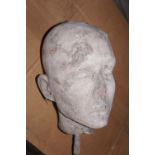 A concrete head of a woman. Height 9 ins.