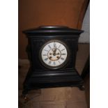 A late Victorian good quality marble mantel clock with bronze lion mask ring handles, white enamel