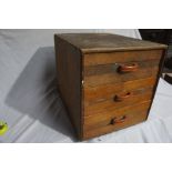 A 1930s walnut veneered small three drawer chest with orange bakelite handles, Height 14.5ins, Width