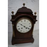 A late 19thC mahogany bracket clock with brass ball finials, brass columns, white enamel dial, Roman