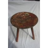 A painted wooden three legged stool with a circular top, Height 14ins