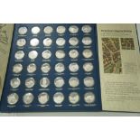 A collection of Betjeman's bygone Britain thirty six sterling silver proof medals, cased with