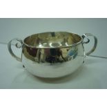 Arts & Crafts circular two handled silver bowl with hand beaten decoration, London 1907 7.5 ozt