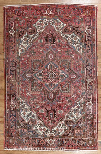 Persian Heriz Carpet, red ground, central medallion and spandrels, repeating floral border, 7 ft.