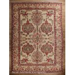 Persian Bakhshish Carpet, tan ground, repeating central medallions in red, green, blue and brown, 10