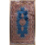 Heriz Carpet, central astral blue ground with central medallion and spandrels, stylized burgundy