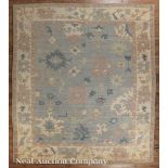 Oushak Carpet, light blue ground, stylized floral design in rose, dark blue and cream, 8 ft. 3 in. x