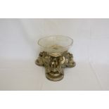 An Elkington plate centrepiece in the form of three swans surrounded by mask and swag decoration,