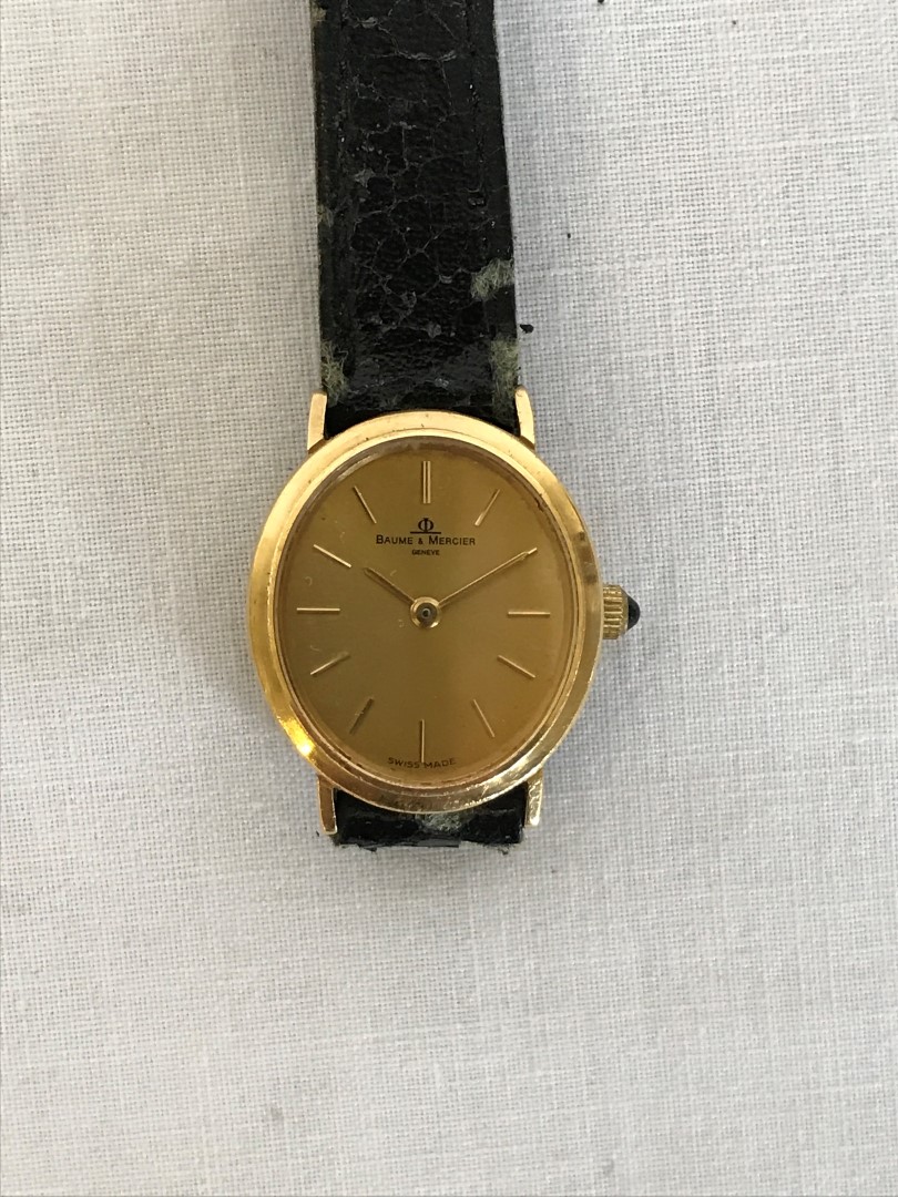 A Baume & Mercier ladies gold coloured metal cased wristwatch, the oval dial with baton numerals and