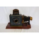 A Victorian magic lantern projector by Thornton Pickard on a mahogany plinth base. Est £150-200