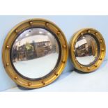 Two gilt painted, graduated convex mirrors modelled as portholes.