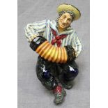 A Royal Doulton ceramic figure, 'Jolly Sailor,' HN2172, of a sailor playing a concertina. 16.5cm