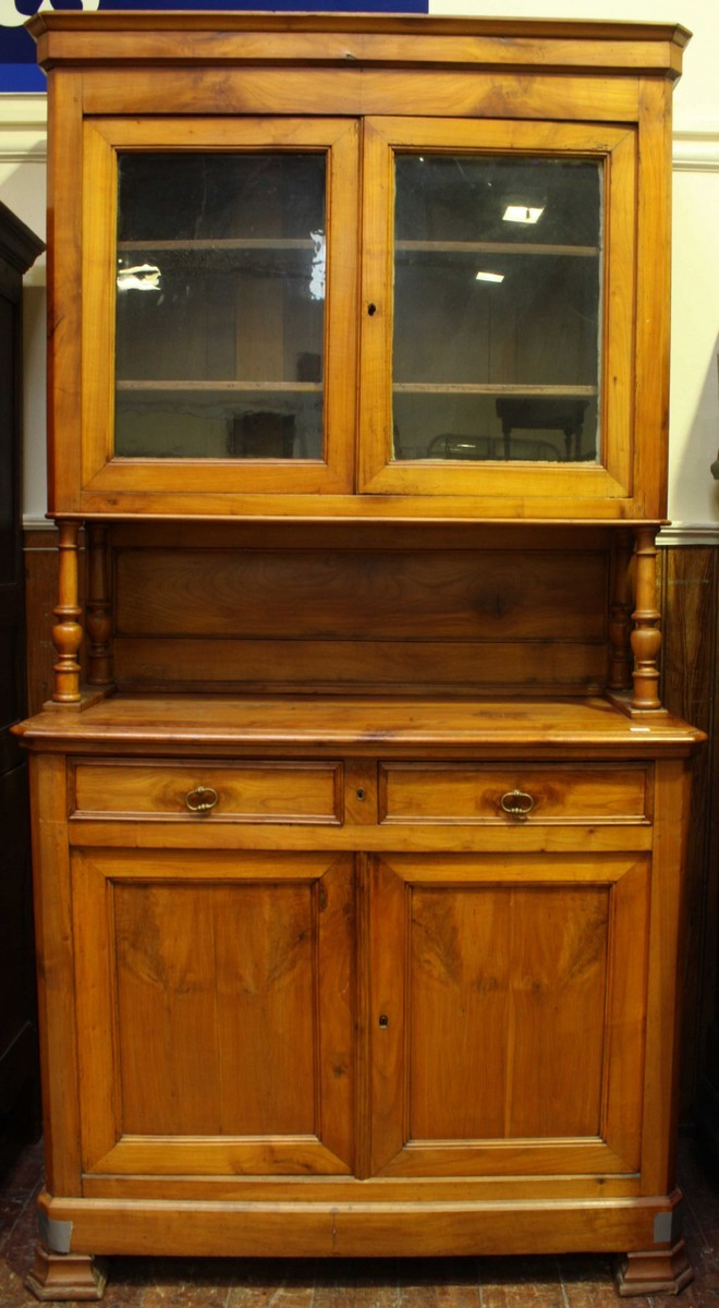 A French cherry-wood two-tier deux corps, the shaped cornice above two glazed cupboard doors