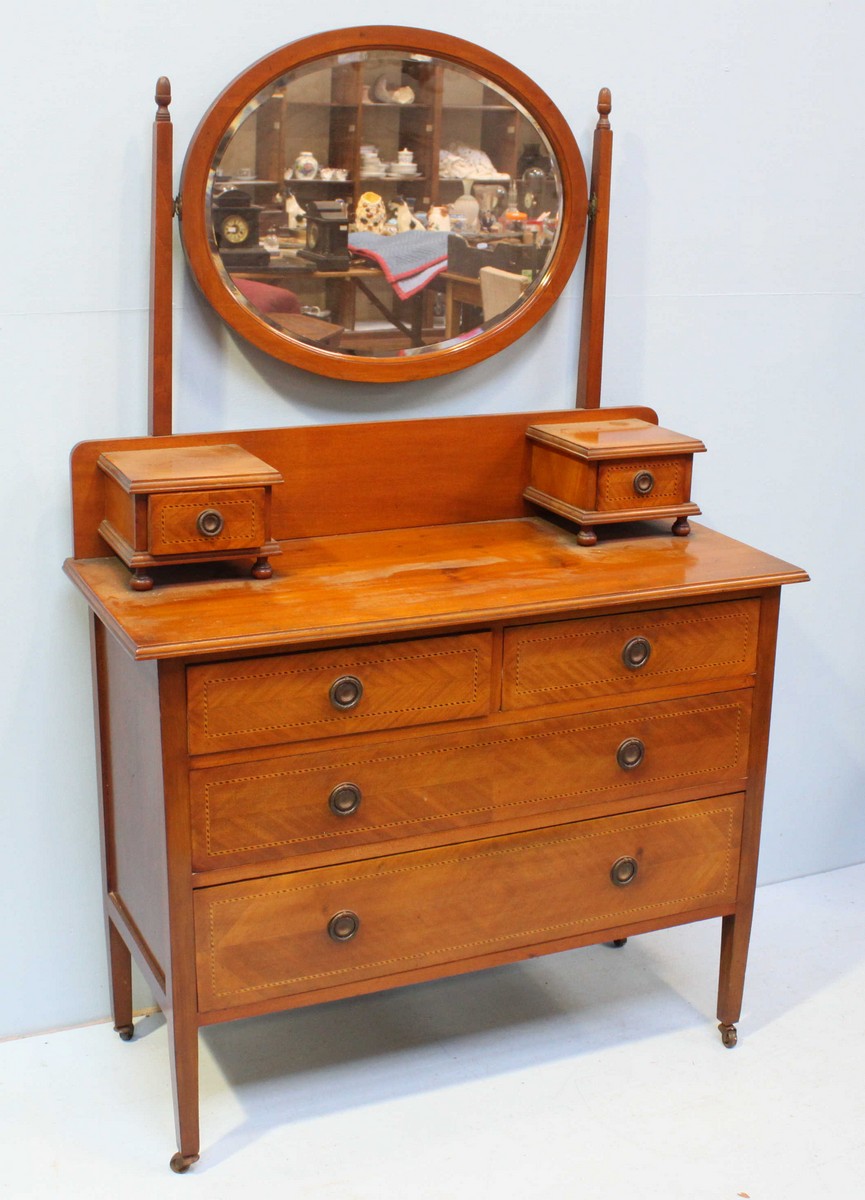 An Edwardian inlaid mahogany dressing table, with oval mirror above two short over two long