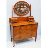 An Edwardian inlaid mahogany dressing table, with oval mirror above two short over two long