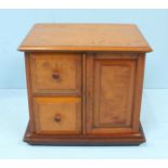 A Satinwood table top storage cabinet consisting 2 square drawers and 1 cupboard door, 34cm high