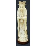 A Qing Dynasty carved Chinese ivory figure of Luxing or Ts'ao Kuo-Chiu, modelled wearing court dress