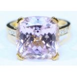 An 18ct gold Kunzite and diamond ring, set with a large central, cushion cut Kunzite (approx