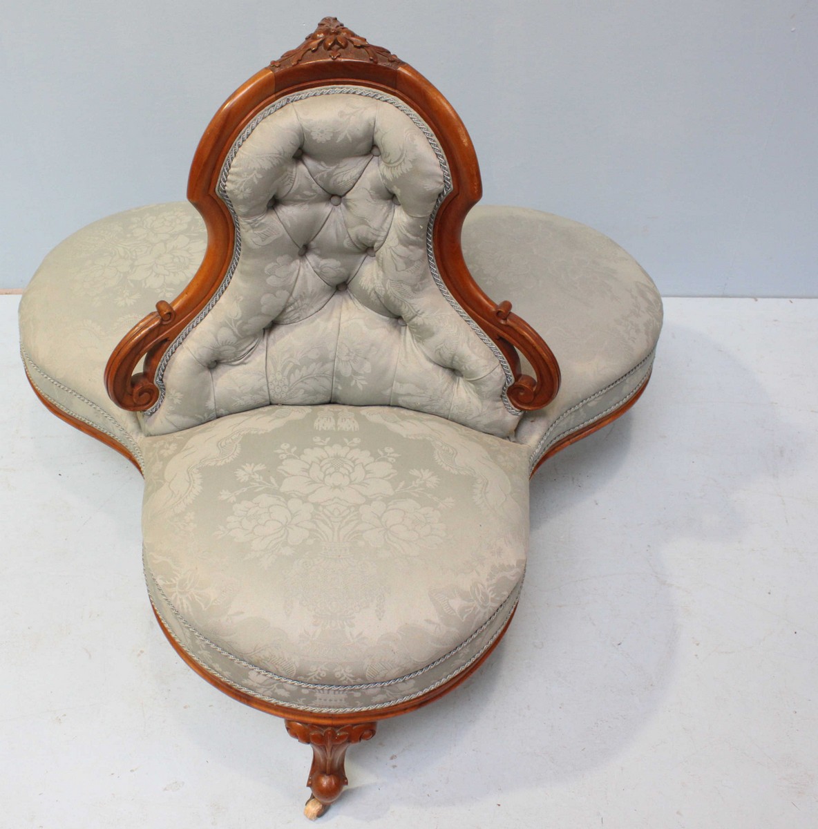 A Victorian walnut conversation sofa of trefoil form, with floral carved decoration, button back, - Image 3 of 3