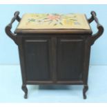 An early 20th century piano seat, the cushion embroidered with a floral design with scrolling