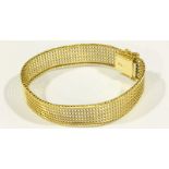 An 18ct gold woven wide-band bracelet with slide fastening and double safety catch. Gross weight