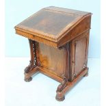 A Victorian walnut Davenport desk, the hinged, sloped front with gilt tooled leather scribe, opening