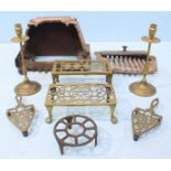 A cast iron fire grate together with a selection of various brassware including a brass fender, a