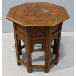 An Anglo-Indian octagonal hardwood occasional table, with foliate brass inlay and baring label for