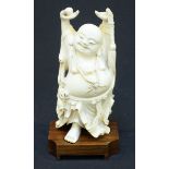 A Qing Dynasty Chinese carved ivory figure of the 'happy Buddha' Ho Tai, modelled with his hands