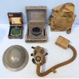 A WW2 military helmet and a 'Barringe Wallis and Manners' gas mask, together with a compass housed