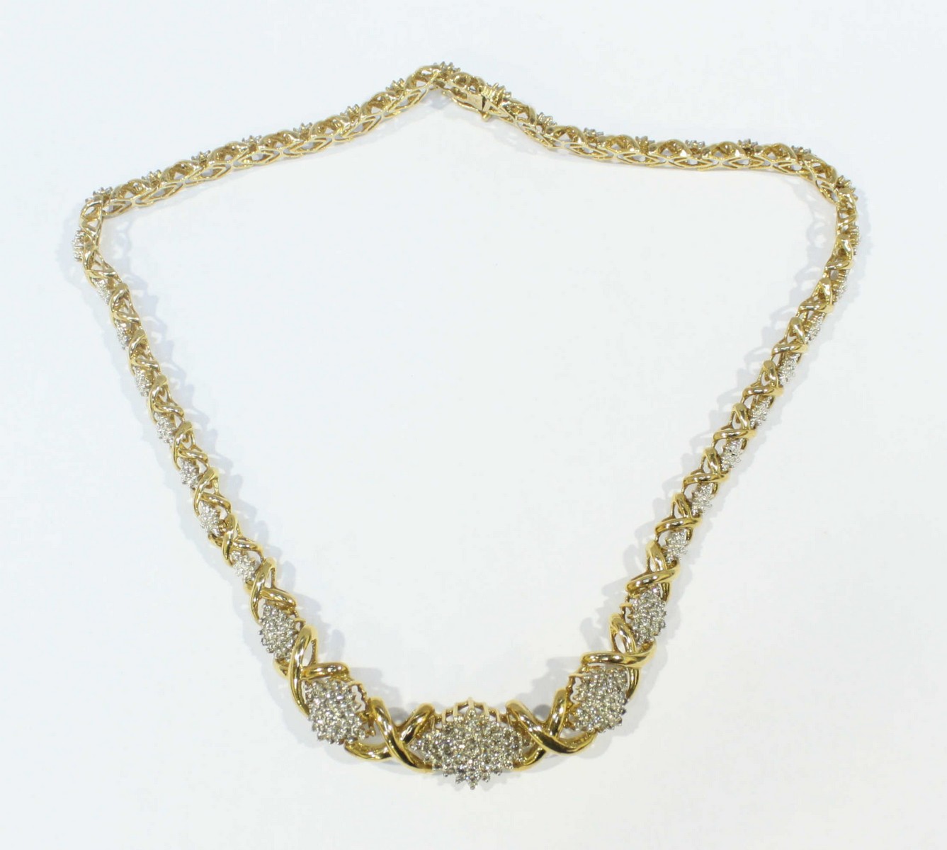A 9ct yellow gold and diamond necklace with alternating, graduated 'X' shape links and symmetrical