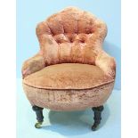 A Victorian Nursing chair with Pink velvet upholstery, on turned supports with castors, 78cm high