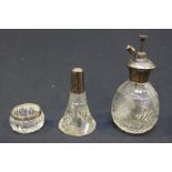 Three various items of silver topped glass including an atomizer, a bottle and a small dish.