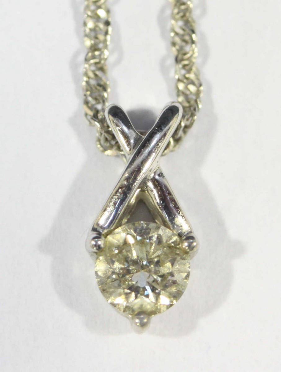 A 9ct gold solitaire diamond pendant and fine necklace chain, RBC diamond weighing approximately 0.