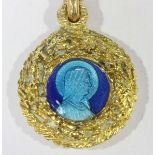 An 18K stamped circular necklace pendant with double-sided blue enamel Virgin Mary decorated centre,
