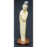 A Qing Dynasty Chinese carved ivory figure of the Immortal Lu Dongbin, modelled with hair tied up